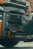 Model year 2025 : Renault Trucks T High Smart Racer : lifestyle (driver sitting on the windscreen access steps, relaxing with a cup in his hands)(Renault Trucks Stoneware Mug)(Renault Trucks Hero Zip Hoodie)