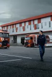 Model year 2025 : Renault Trucks T High Smart Racer in a logistics centre; lifestyle (Renault Trucks bodywarmer, Renault Trucks hoodie)